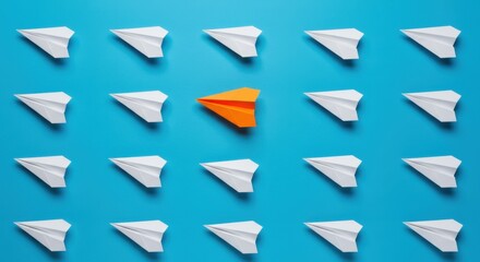 Individuality Concept with an Orange Paper Airplane Standing Out