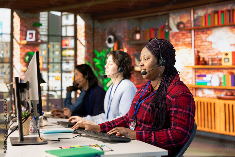 Poster multiethnic teamworking call center agents at office desk handling customer inquiries, complaints an