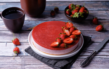 Strawberry mousse cake in a plate on a wood background