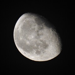 Detailed view of the moon's surface at night.