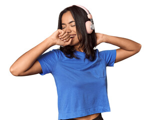 Joyful Filipino woman dancing with headphones