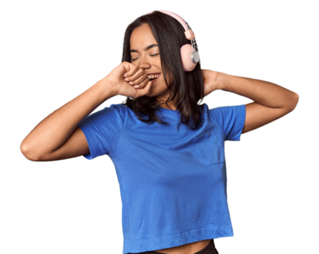 Joyful Filipino woman dancing with headphones