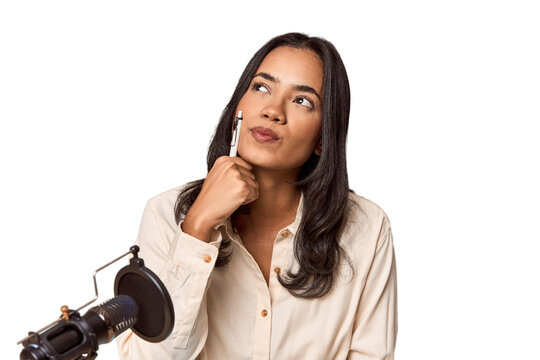Filipino woman podcasting with mic and laptop