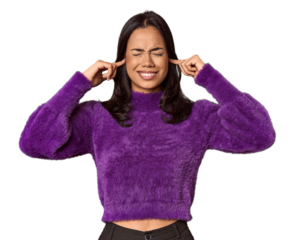 Young filipino woman covering ears with fingers, stressed and desperate by a loudly ambient.