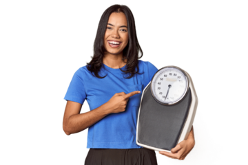Filipino woman with scale in studio smiling and pointing aside, showing something at blank space.