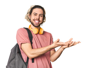 Young student with backpack and headphones holding a copy space on a palm.
