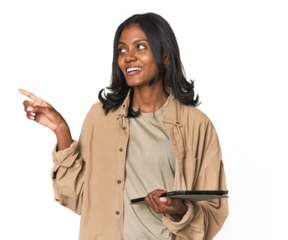 Young Indian woman with digital tablet smiling and pointing aside, showing something at blank space.