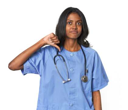 Young Indian nurse with stethoscope showing a dislike gesture, thumbs down. Disagreement concept.