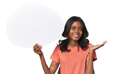 Indian woman with dialogue bubble showing a copy space on a palm and holding another hand on waist.
