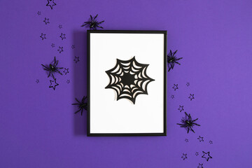 Festive Halloween background design. Frame with spider web surrounded by spiders and stars on...