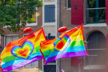 Colour of Amsterdam gay pride, People waving colourful rainbow flag for parade while the boat sailing in the canal, LGBT annual festival to celebration, The greatest events in the world, Netherlands.