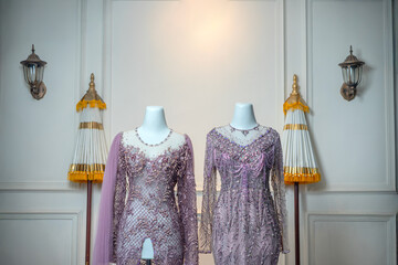 Two luxurious purple wedding and evening gowns with intricate bead and sequin details, beautifully...