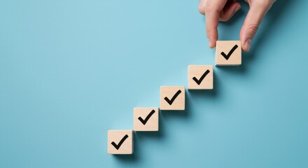 Checklist success concept with hand placing last checkmark on wooden cubes symbolizing completion and progress
