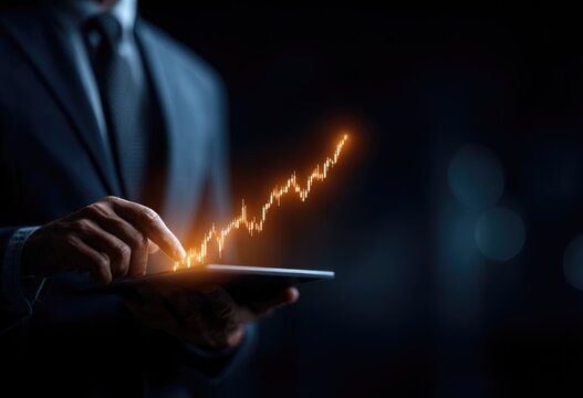 Businessman interacts with glowing upward stock chart on tablet - Powered by Adobe