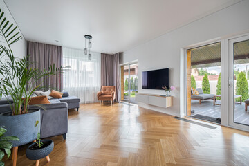 Modern living room with large window and contemporary furnishings in a cozy house setting