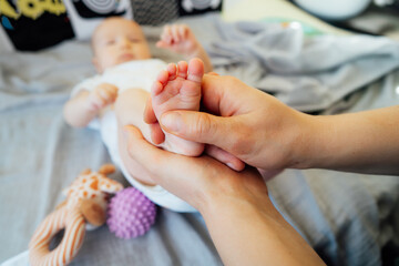 Close up Father massages baby's legs by fingers and with massage ball. Healthy massage. Massage therapist. Sensory tactile activities. Massage textured balls for kid. Earlier development. Focus picked