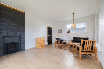 Cozy living area featuring wooden furniture and a stylish fireplace in a modern interior design