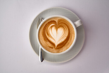A Warm Cup of Coffee Featuring a Beautiful Heart Latte Art Design that Invites You to Indulge in...