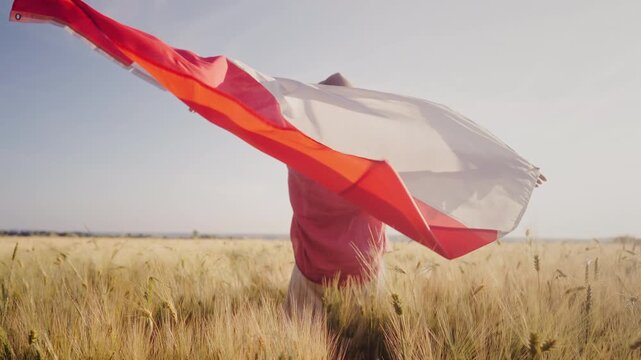 Polish Woman Stands In Wheat Field Holding National Flag in Wind
