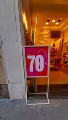 A striking sign announces discounts "Up to 70%" on selected products, a common strategy in the face of economic instability 