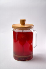 Elegant Glass Teapot with a Wooden Lid Filled with a Rich and Inviting Red Tea Infusion, Perfectly Brewed for a Refreshing Beverage Experience