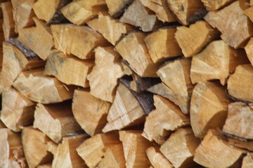 Chopped stacked wooden logs textured abstract background wallpaper 