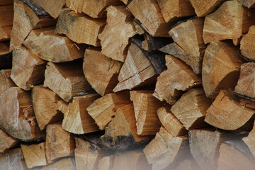 Chopped stacked wooden logs textured abstract background wallpaper 