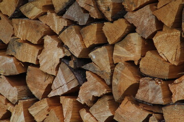 Chopped stacked wooden logs textured abstract background wallpaper 
