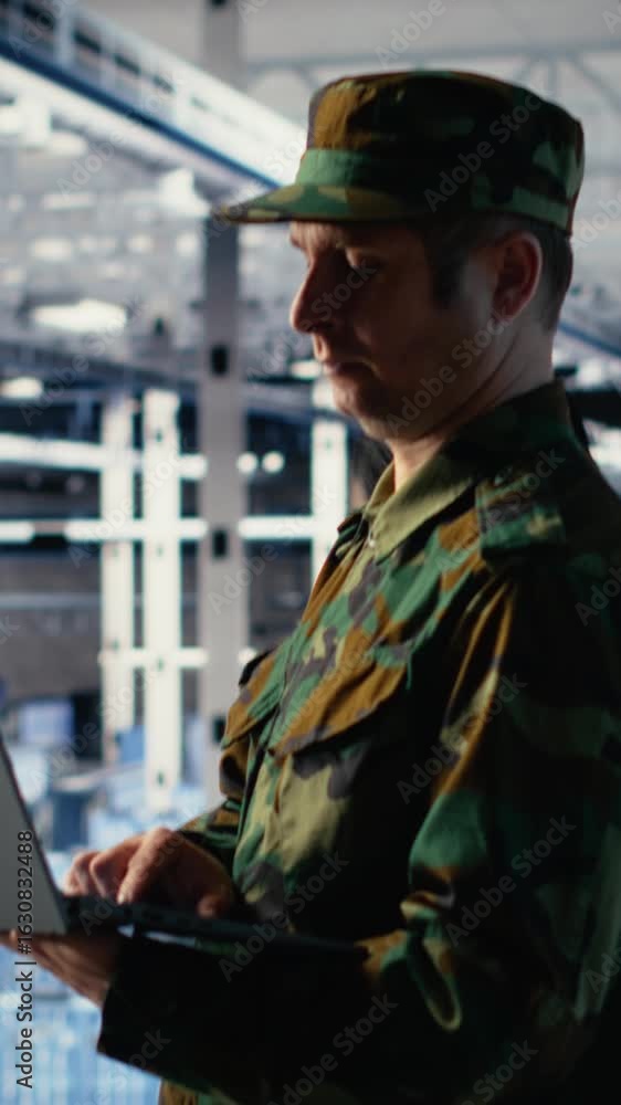 Poster vertical video army soldier in server farm uses artificial intelligence program on laptop to review 
