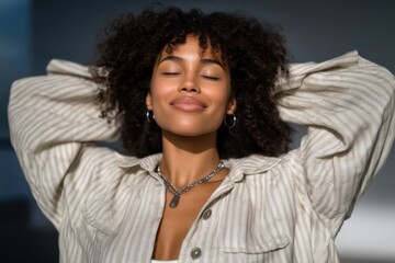 Relaxed young woman enjoying tranquility with eyes closed and a joyful expression in a serene minimalist environment radiating positive energy and emotional freedom