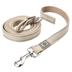 Close up of a beige fabric dog leash with a metal clip coiled and extended on a transparent background isolated on transparent background