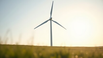 Fototapeta premium Wind turbine in field at sunrise