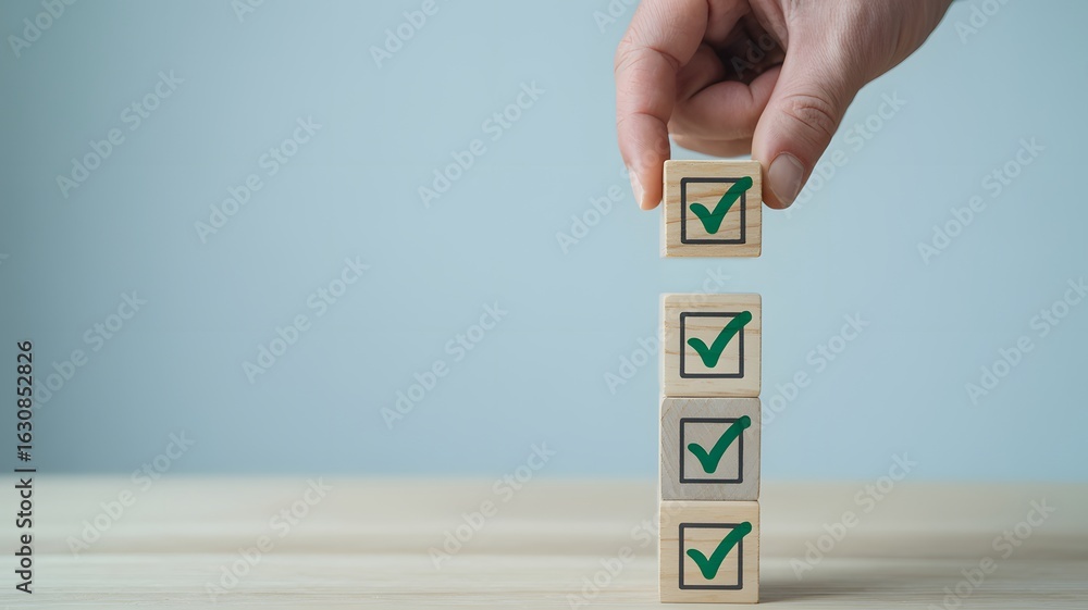 Poster hand placing wooden cube with green check mark on stack showing completed tasks or successful checkl
