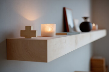 simple wooden shelf adorned with cross and candle radiating warmth and tranquility