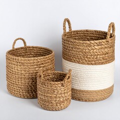 Obraz premium Set of Three Woven Baskets in Brown White and Straw Colors for Home Storage