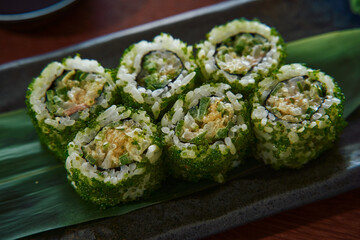 Delicious Sushi Rolls Laid Out on a Leafy Platter, Showcasing Fresh Ingredients, Vibrant Colors, and Culinary Artistry in a Traditional Japanese Dish
