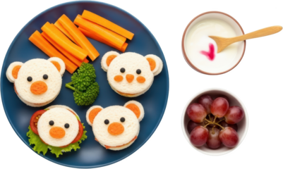 Kid friendly sandwiches shaped like bear faces with carrots broccoli yogurt and grapes transparent background