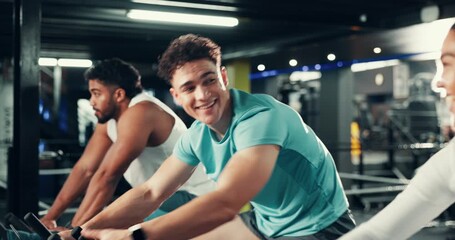 Fitness, cycling class and people with fist bump in gym for cardio workout, training or challenge together. Group, man and athletes on stationery bicycle for spinning exercise in sports center.