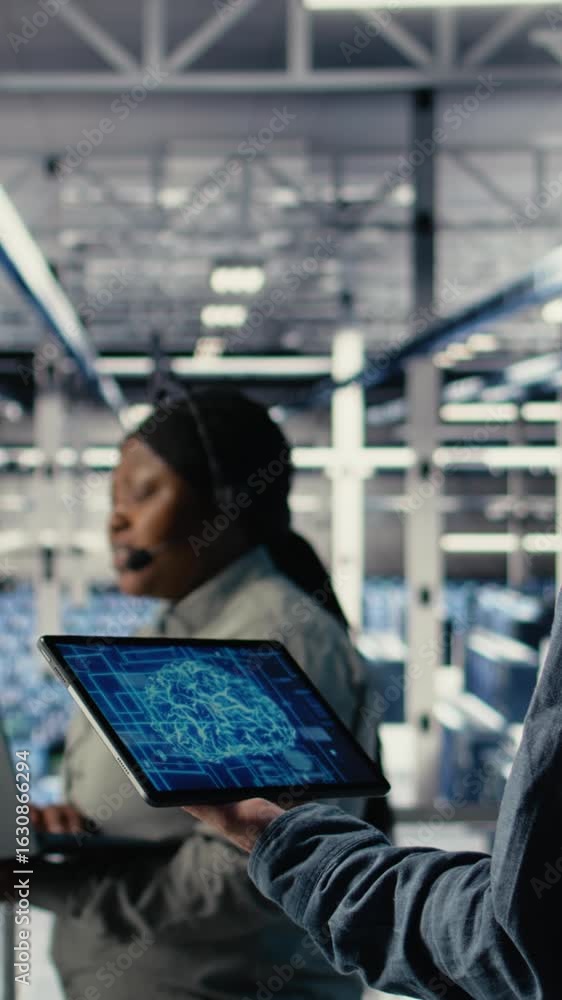 Poster vertical video data center system administrator monitors deep learning processes, reviewing operatio