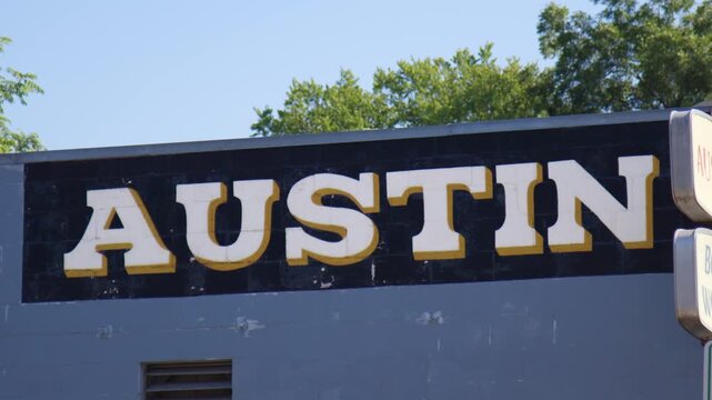 Austin Texas Sign with Bright Blue Sky and Background Trees