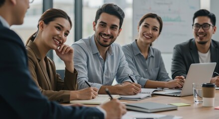 Diverse group of smiling business professionals collaborating in a productive team meeting at a modern office conference room.
