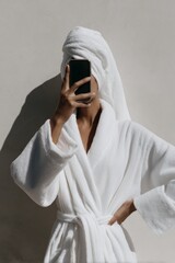 Relaxation and self-care concept with faceless woman in bathrobe taking selfie for spa and beauty routine inspiration