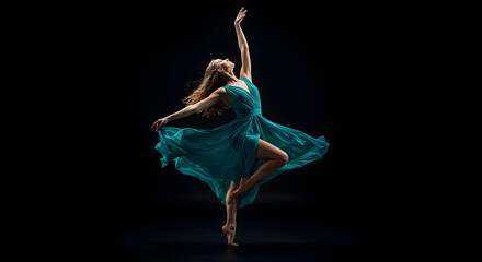 A graceful ballerina in a teal dress performs a beautiful dance against a black backdrop.