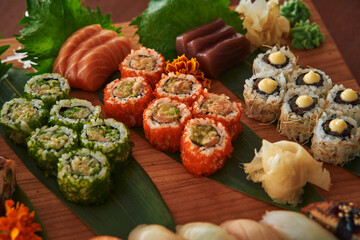 A Colorful Display of Assorted Sushi and Sashimi Arranged on a Wooden Platter Featuring Fresh Ingredients, Intricate Presentation and Varied Textures