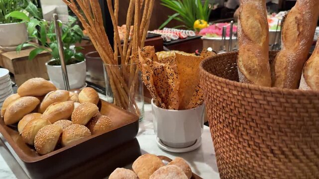 Breadsticks buffet baskets somebody is taking a croissant out of a breadbasket with a pincers