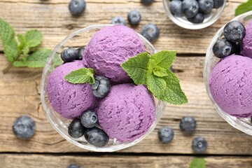 Tasty sorbet with blueberries and mint in dessert bowl on wooden table, flat lay