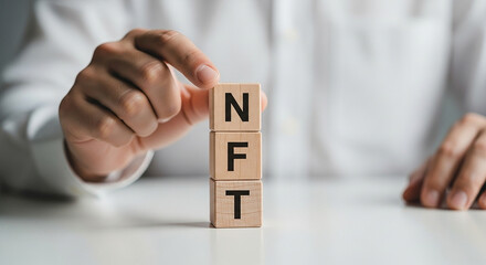 Hand stacking wooden blocks with letters NFT