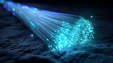 Close view of glowing fiber optic strands spreading light across textured ground.
High speed connectivity and robust broadband capacity power reliable communication for modern networks.