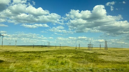 Obraz premium Many high-voltage transmission tower and electricity pylon power lines against blue sky with cloud