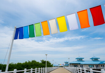 Colorful Flags Flying Over a Pier on a Bright Day